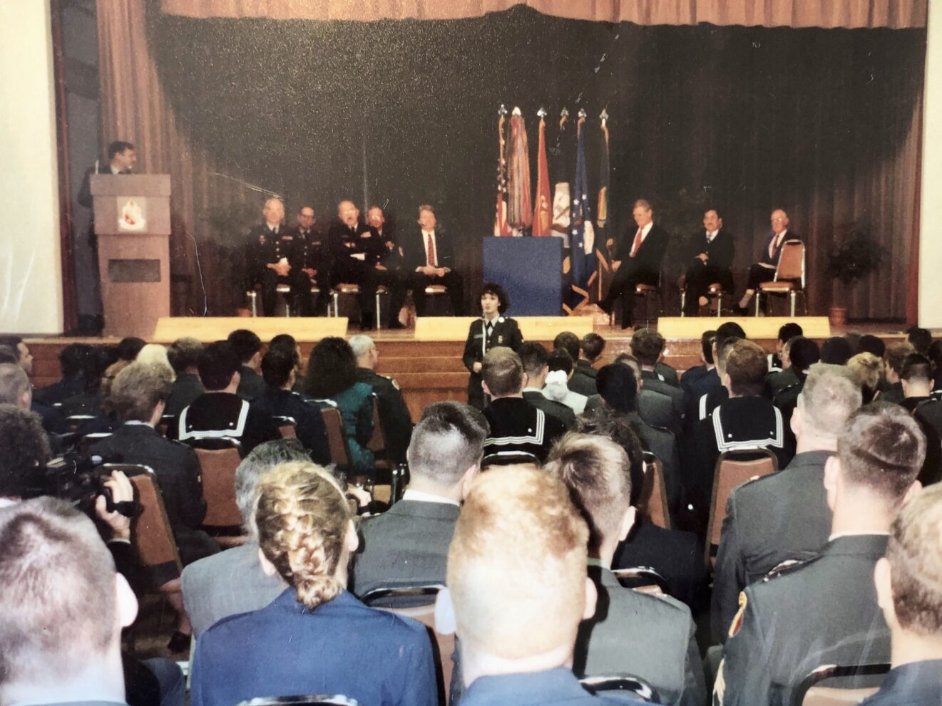 Cristen Reat giving speech to military audience