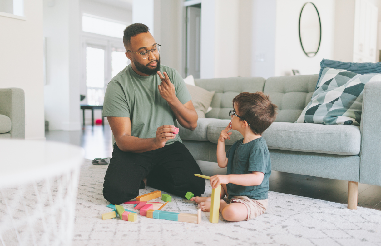 dad and young son communicating with sign language