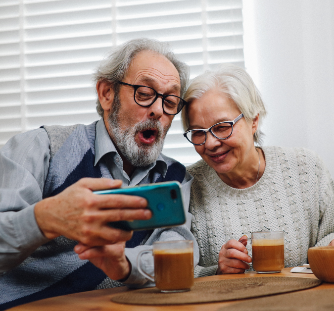 older adult couple using iphone