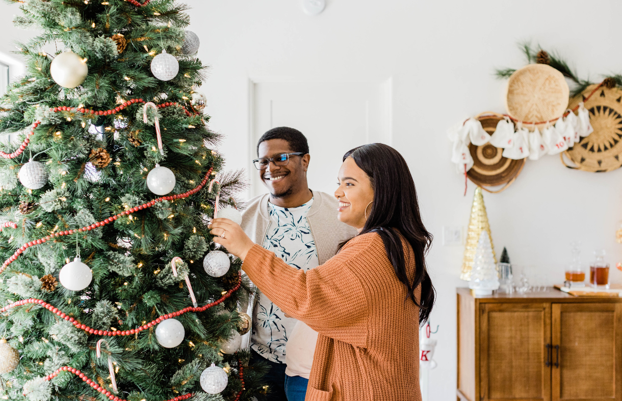 couple decorating christmas tree