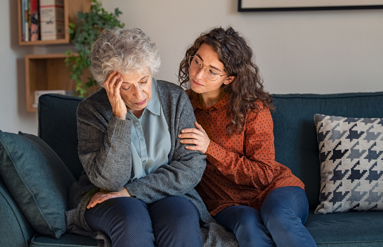 young lady consoling older adult female