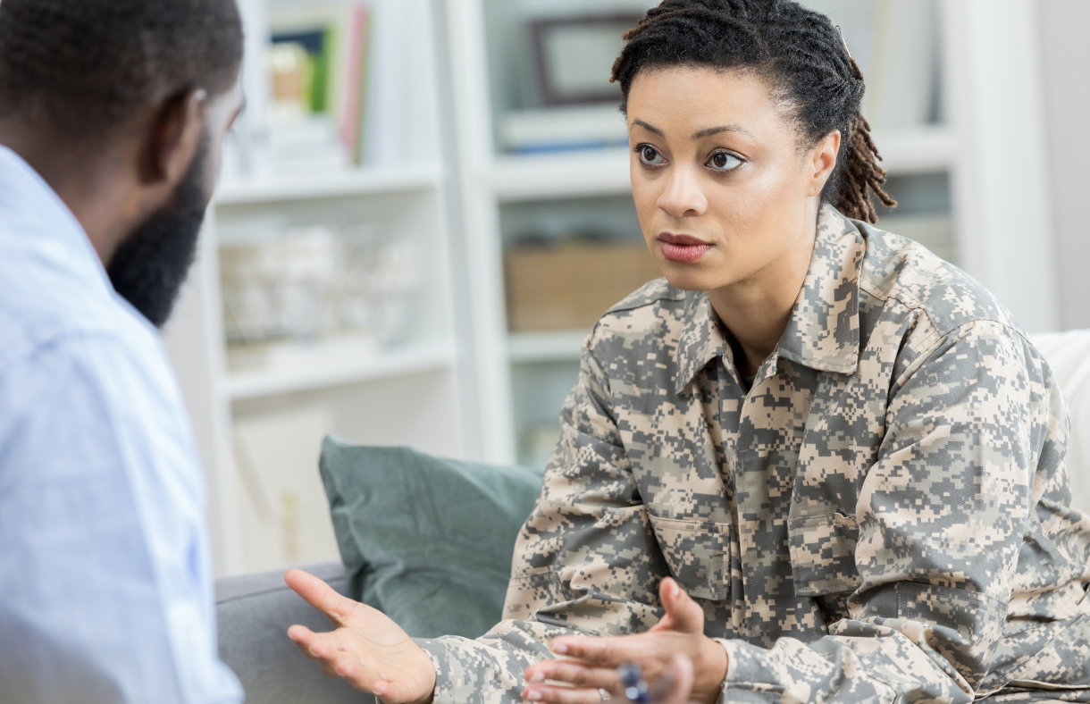 female in military uniform speaking with doctor