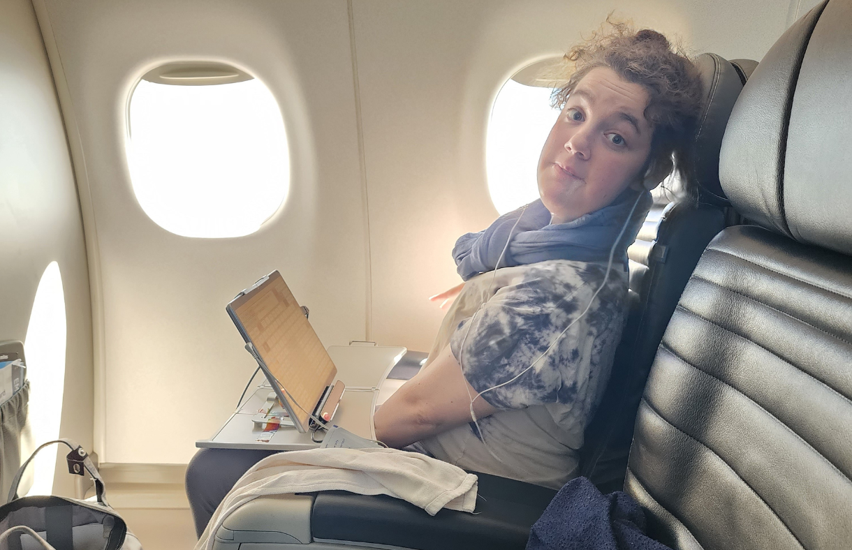 young lady sitting on airplane