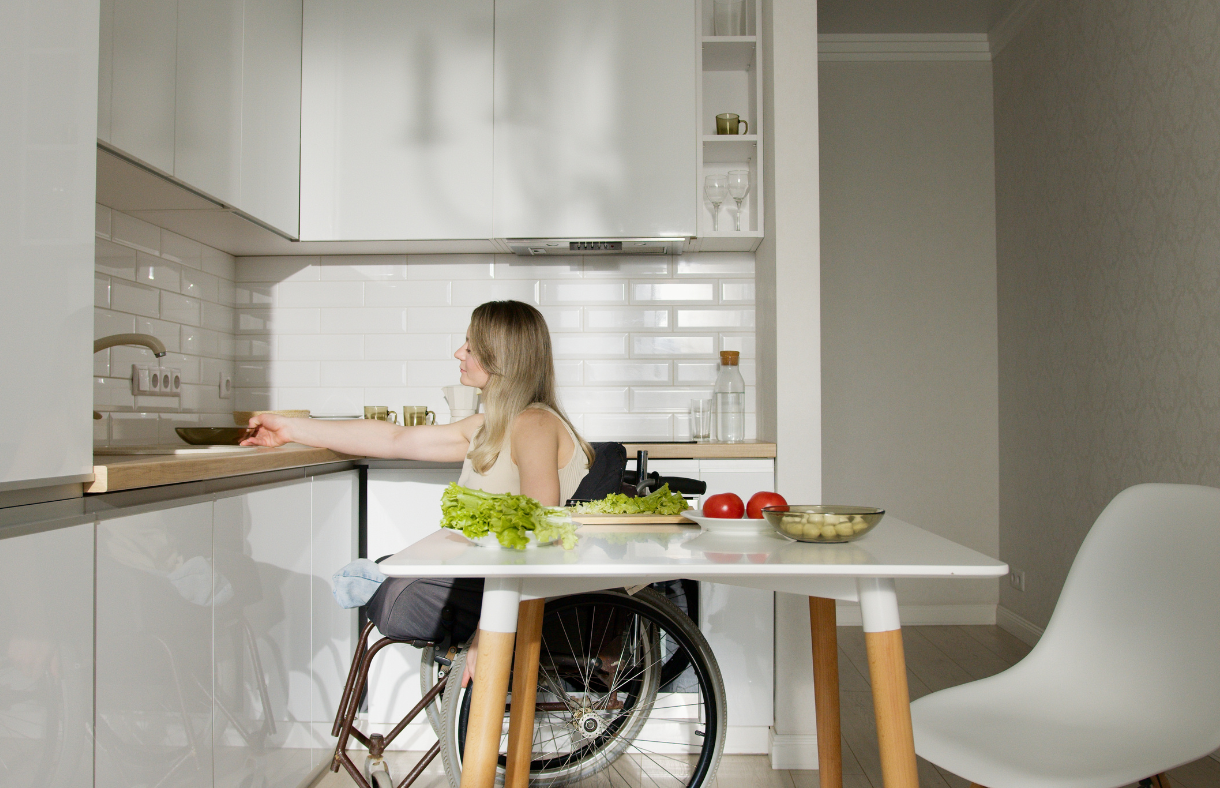 young adult female in wheelchair preparing food in kitchen