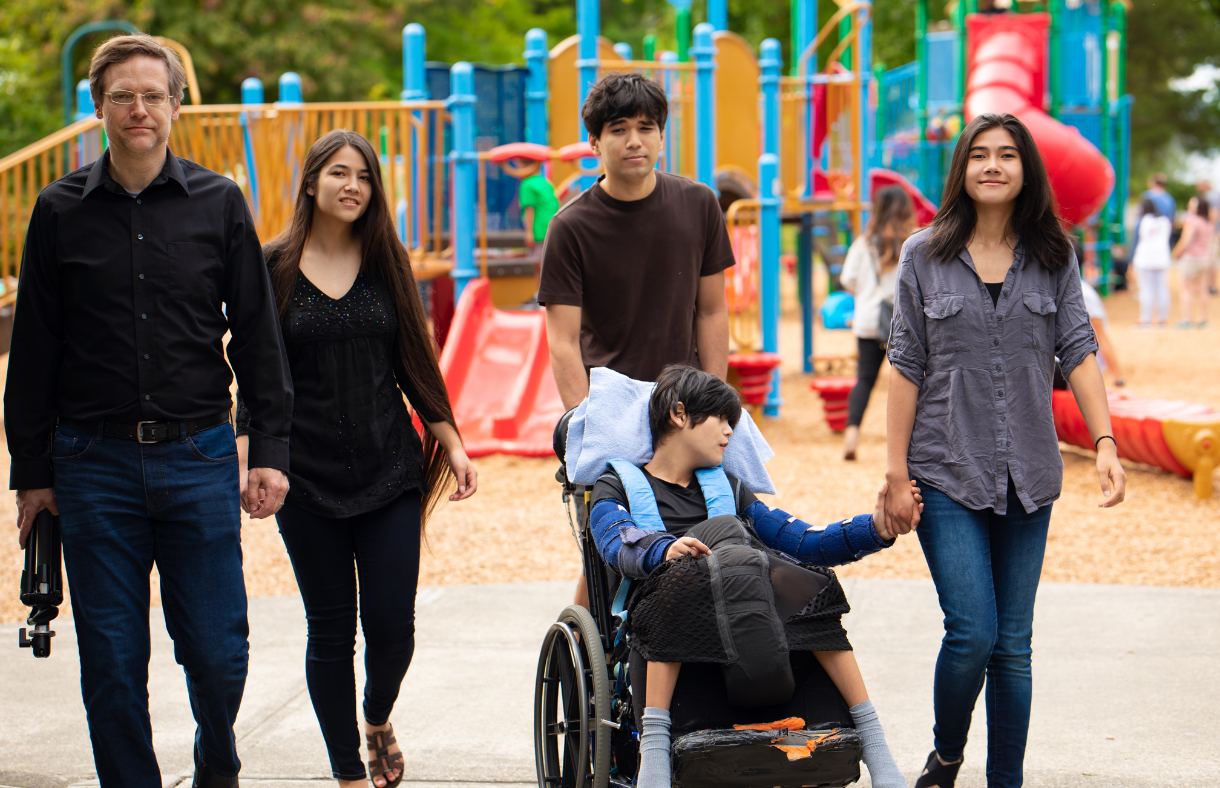 group of 5 siblings, one in wheelchair