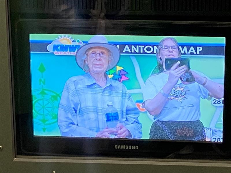 Author and mother reflected in Sensory Village's "San Antonio weather map" screen