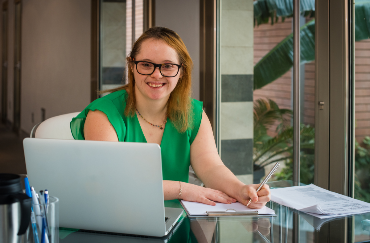 young adult woman with down syndrome working at desk