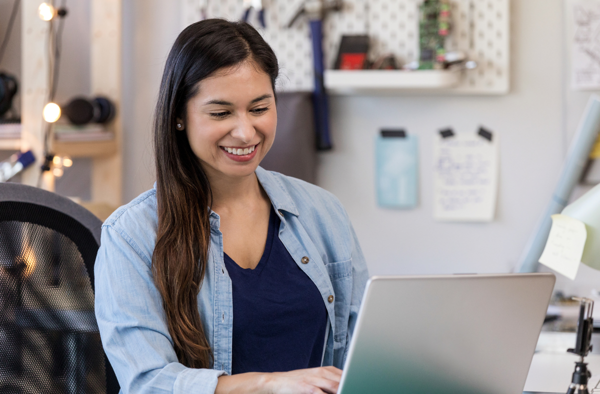 smiling lady looking at laptop screen
