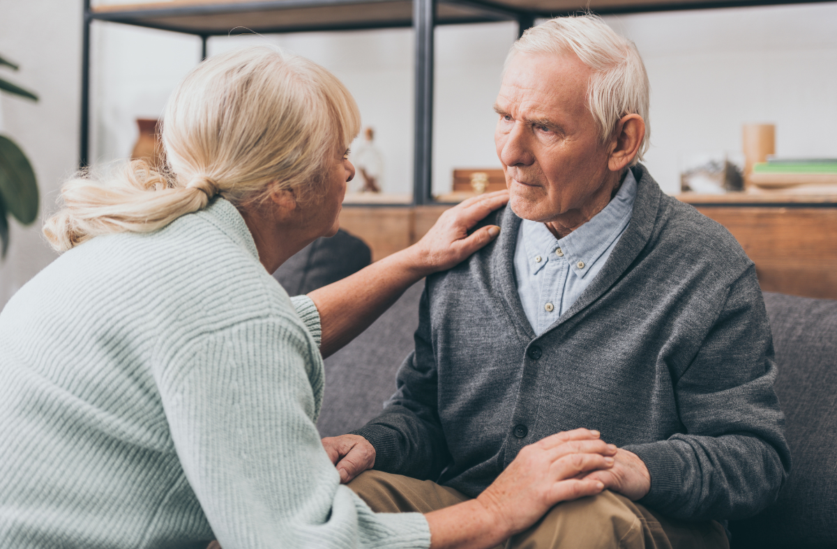 older adult man being helped by woman