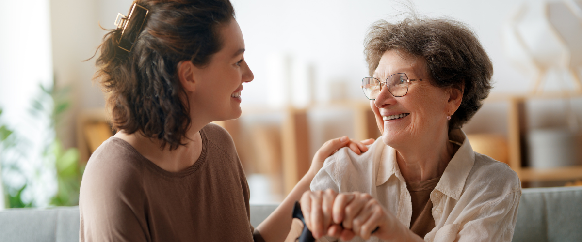 adult woman caregiver helping older adult