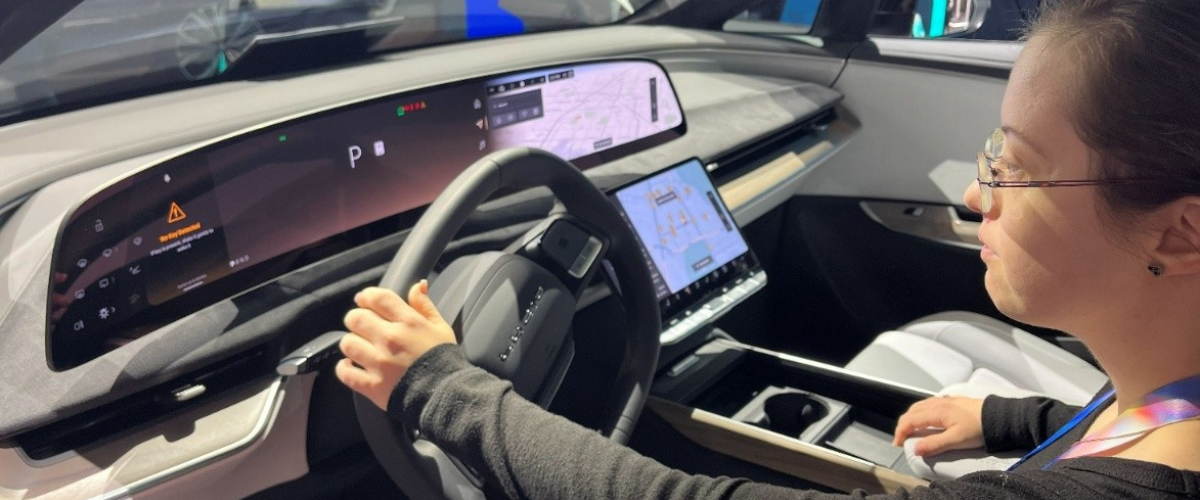 young woman sitting in car at tech conference