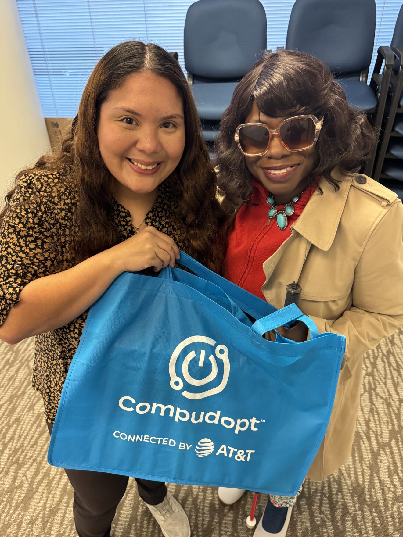 ale and michelle wright holding blue bag that says compudopt
