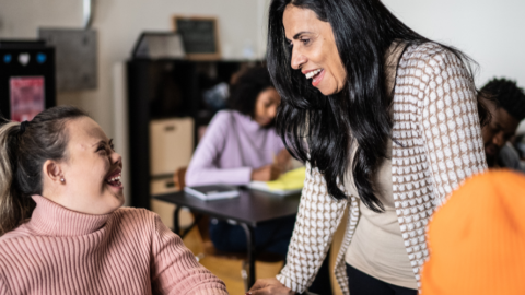 young lady and teacher looking at each other in classroom
