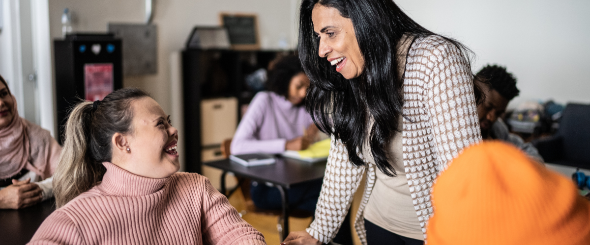 young lady and teacher looking at each other in classroom