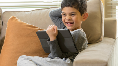 boy w ipad on couch