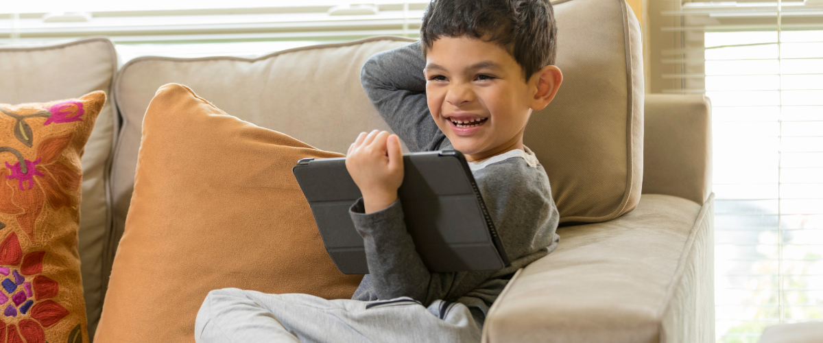 boy w ipad on couch