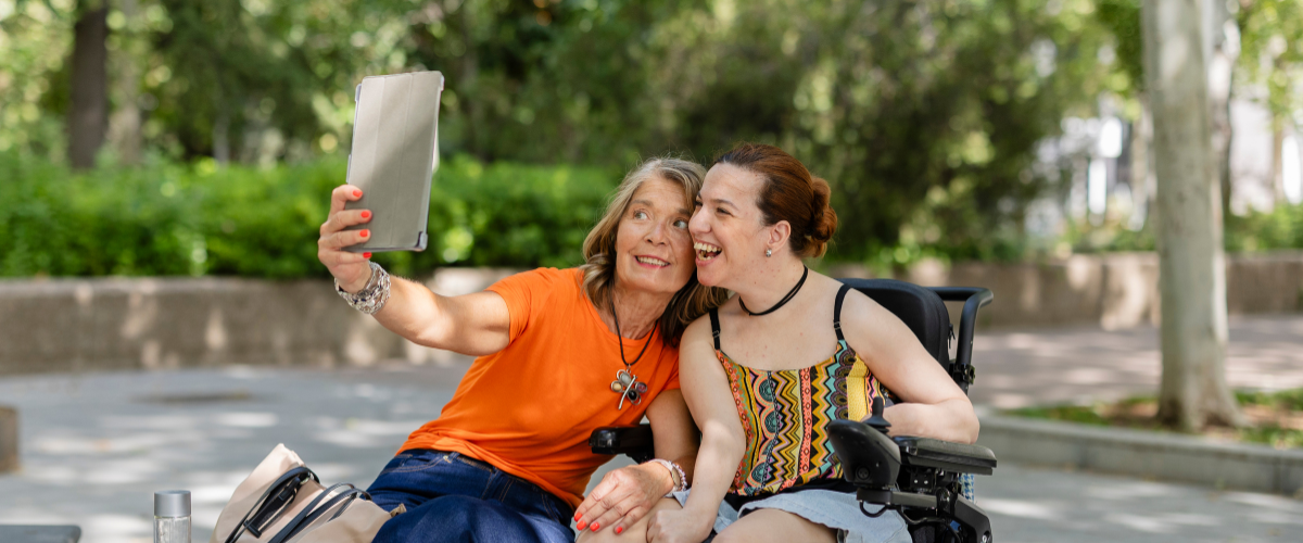 woman in wheelchair taking selfie w friend