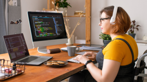 young lady sitting in wheelchair at computer