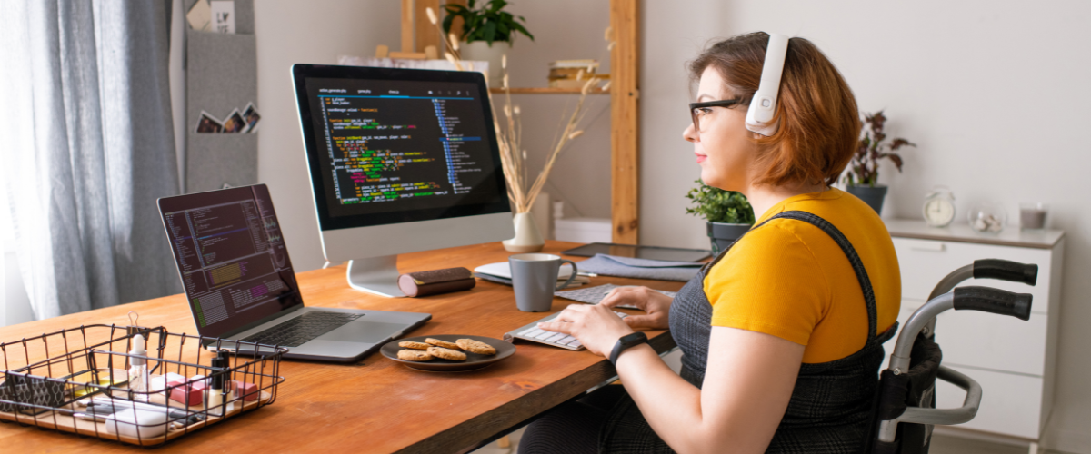 young lady sitting in wheelchair at computer